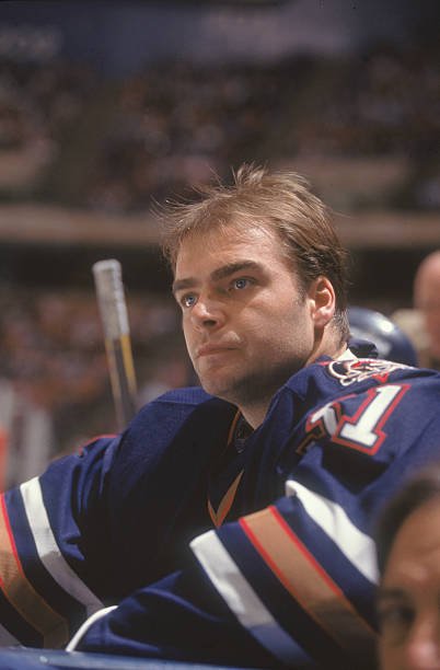 Curtis Joseph watching an Edmonton Oilers game from the bench in the late 1990s