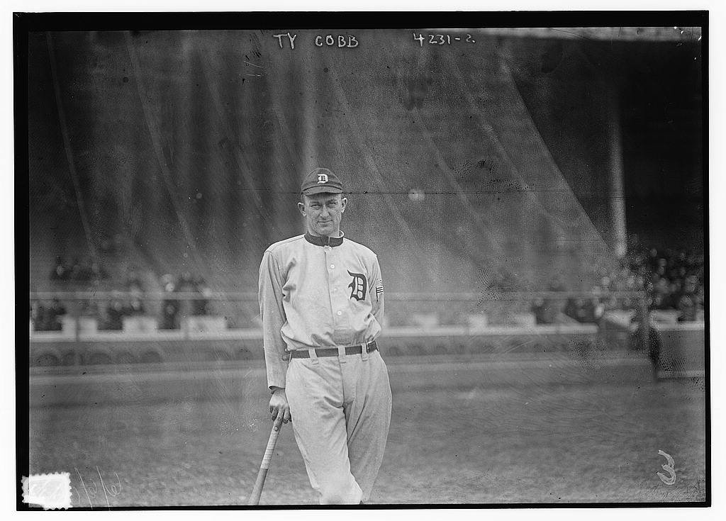 Ty Cobb standing in a Detroit Tigers uniform and holding a baseball bat in 1917