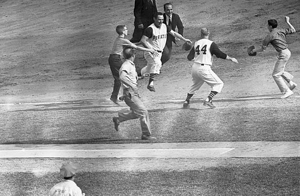 Bill Mazeroski is surrounded by players, officials and fans after his World Series-winning home run at Forbes Field