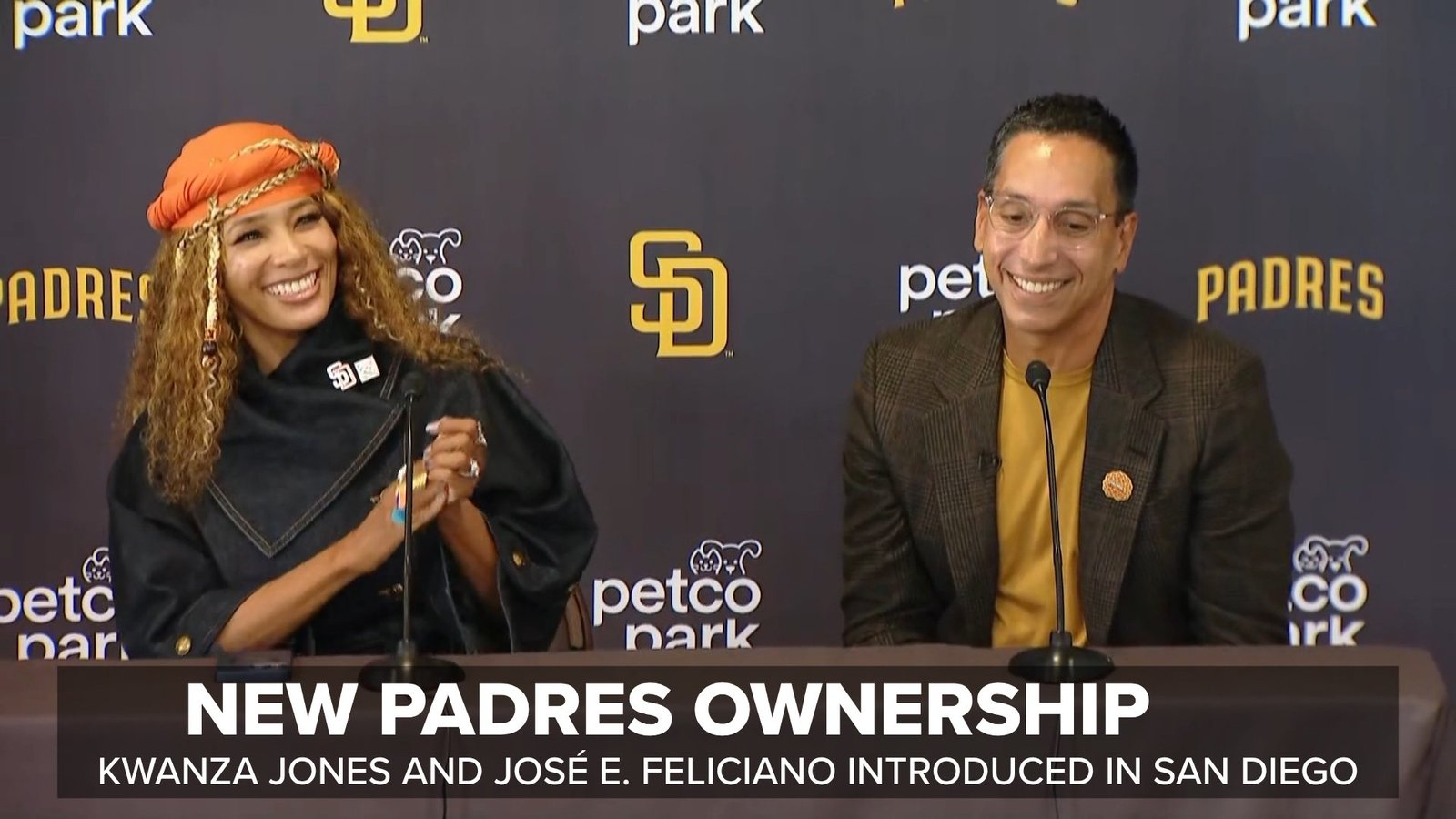 New Padres owners Kwanza Jones and José E. Feliciano hold team jerseys