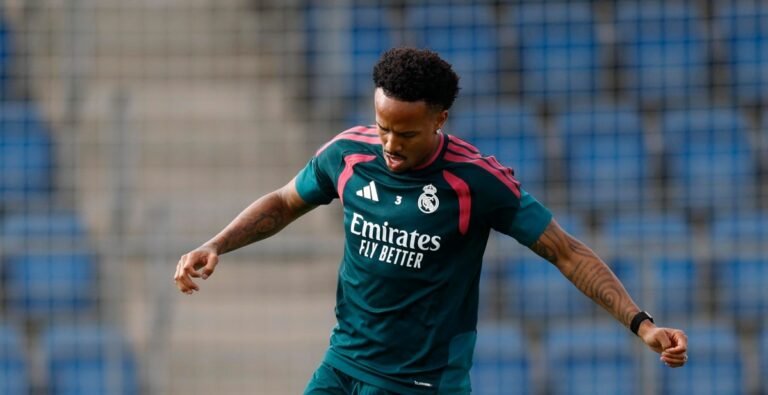 Éder Militão in Real Madrid training kit working with the ball.
