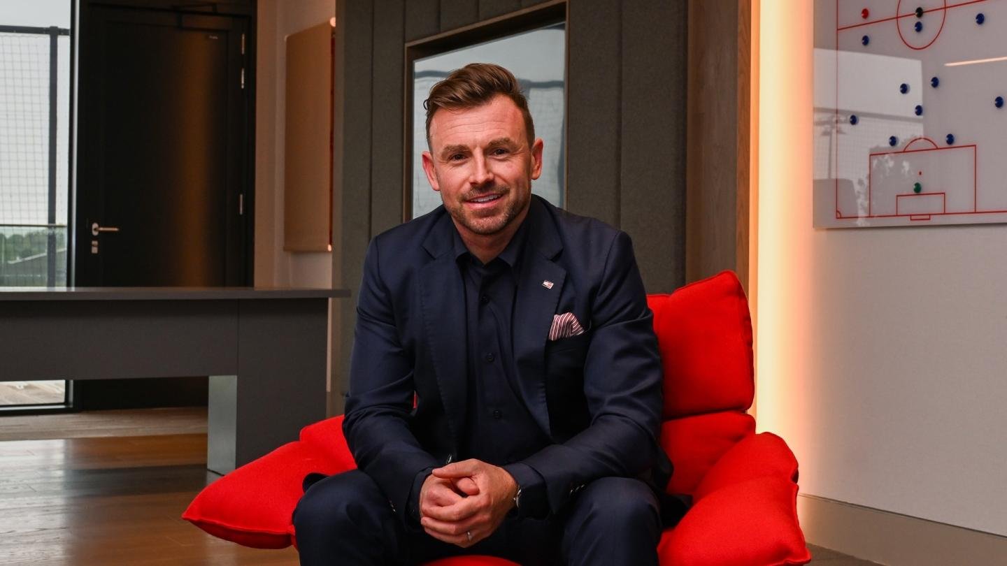 Julian Ward seated at Liverpool’s training facility.