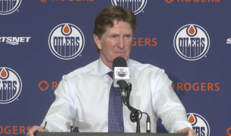 Mike Babcock speaks at the podium after the Oilers’ preseason win over the Winnipeg Jets.