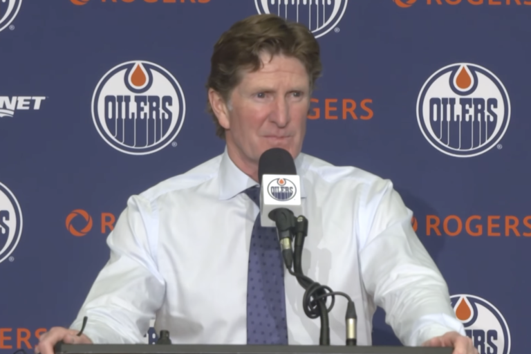 Mike Babcock speaks at the podium after the Oilers’ preseason win over the Winnipeg Jets.