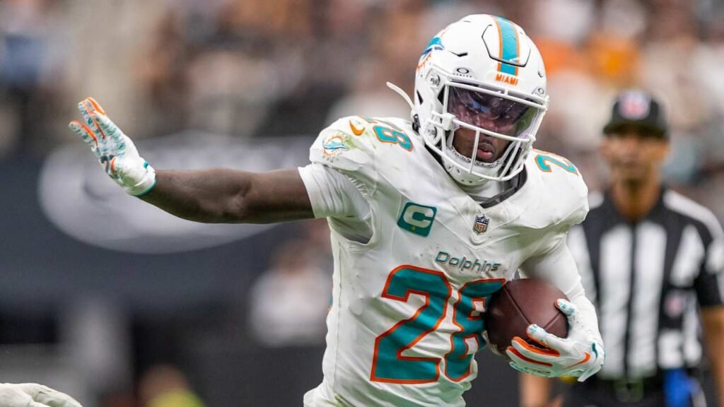 File photo: De’Von Achane carries the ball for Miami. NFL.com published this image with its September 28, 2026 injury report; capture date not supplied.