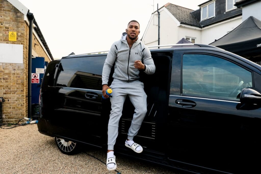 Anthony Joshua beside a minibus after arriving in London for the Tyson Fury fight launch on September 29, 2026