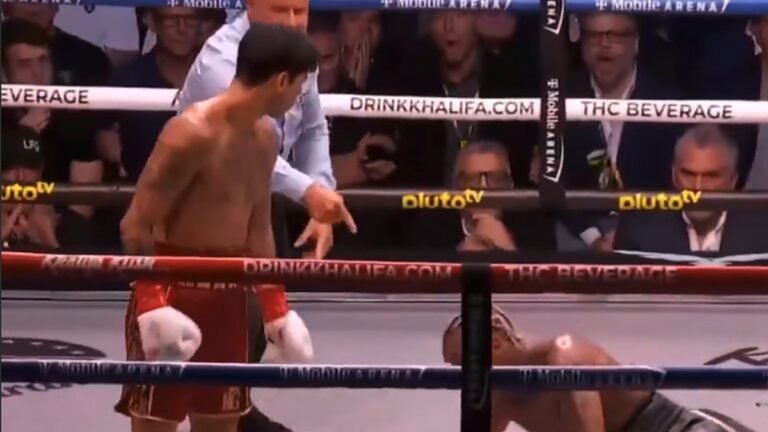Ryan Garcia stands beside Conor Benn, who is down on the canvas after a knockdown.