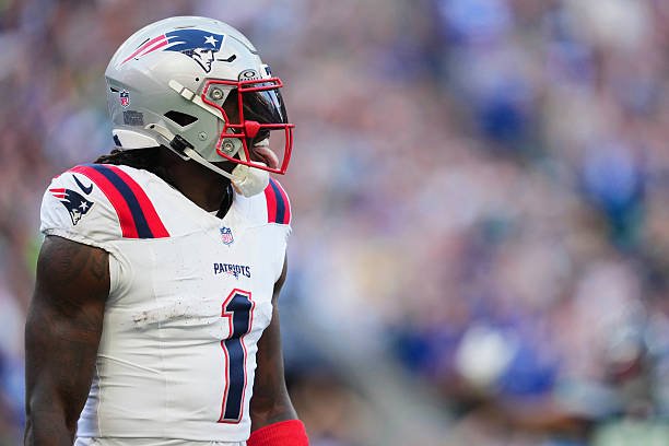 A.J. Brown stands on the field in his New England Patriots uniform during the first half against the Seattle Seahawks.