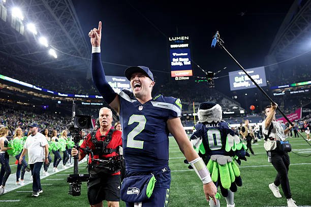 Seattle Seahawks quarterback Drew Lock raises one finger while celebrating a victory over the New England Patriots at Lumen Field.