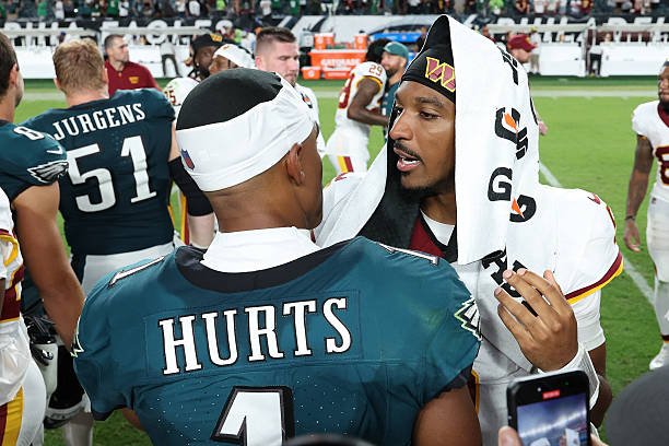 Philadelphia Eagles quarterback Jalen Hurts speaks with Washington Commanders quarterback Jayden Daniels after the Week 1 game.