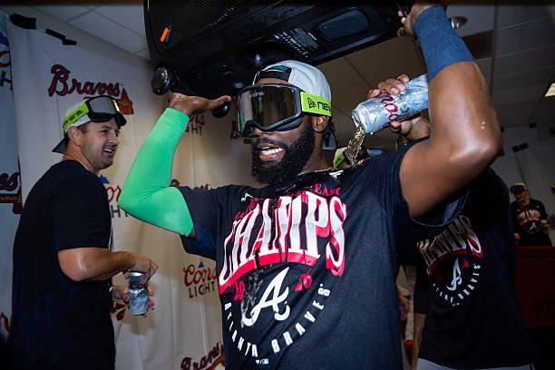 Michael Harris II wearing celebration goggles and an NL East champions shirt after the Braves clinched the division in Houston.