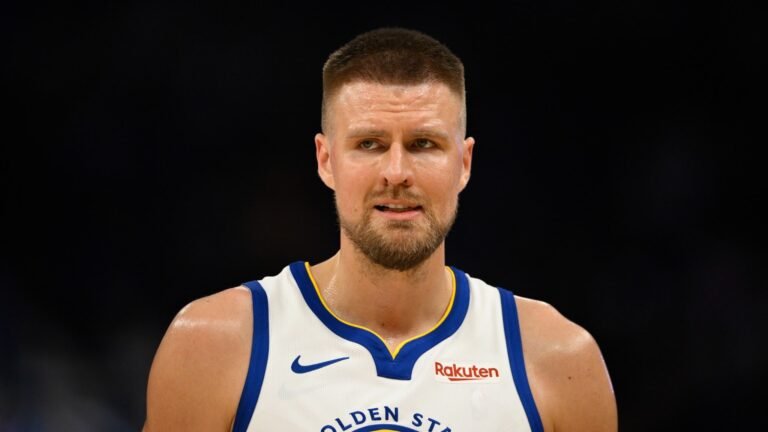 Kristaps Porzingis wearing a Golden State Warriors uniform