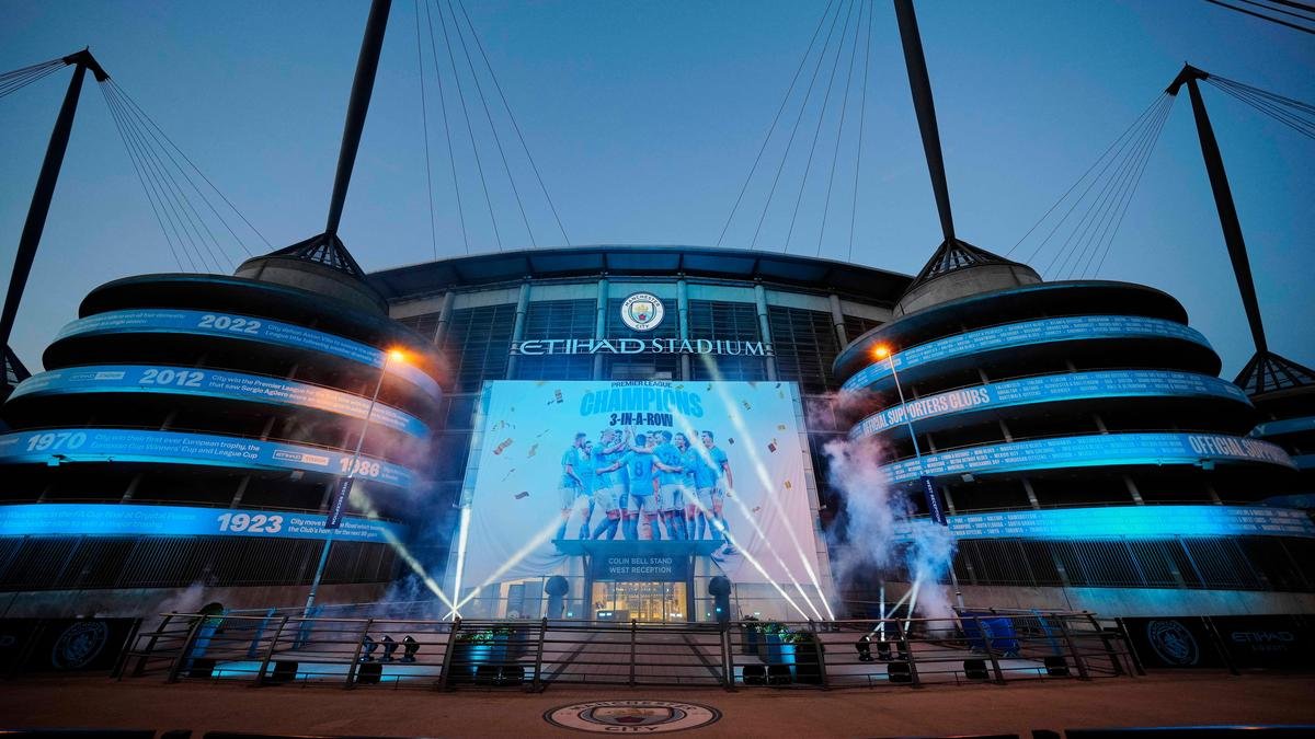 The illuminated exterior of Manchester City’s Etihad Stadium.