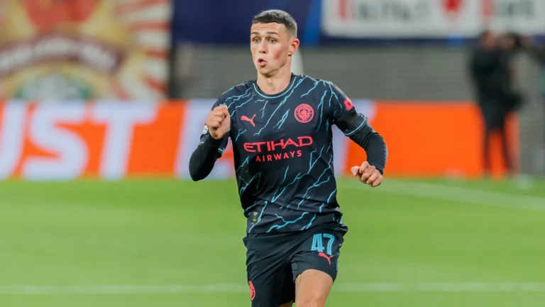 Phil Foden running in Manchester City’s dark away kit during the October 2023 match at RB Leipzig.