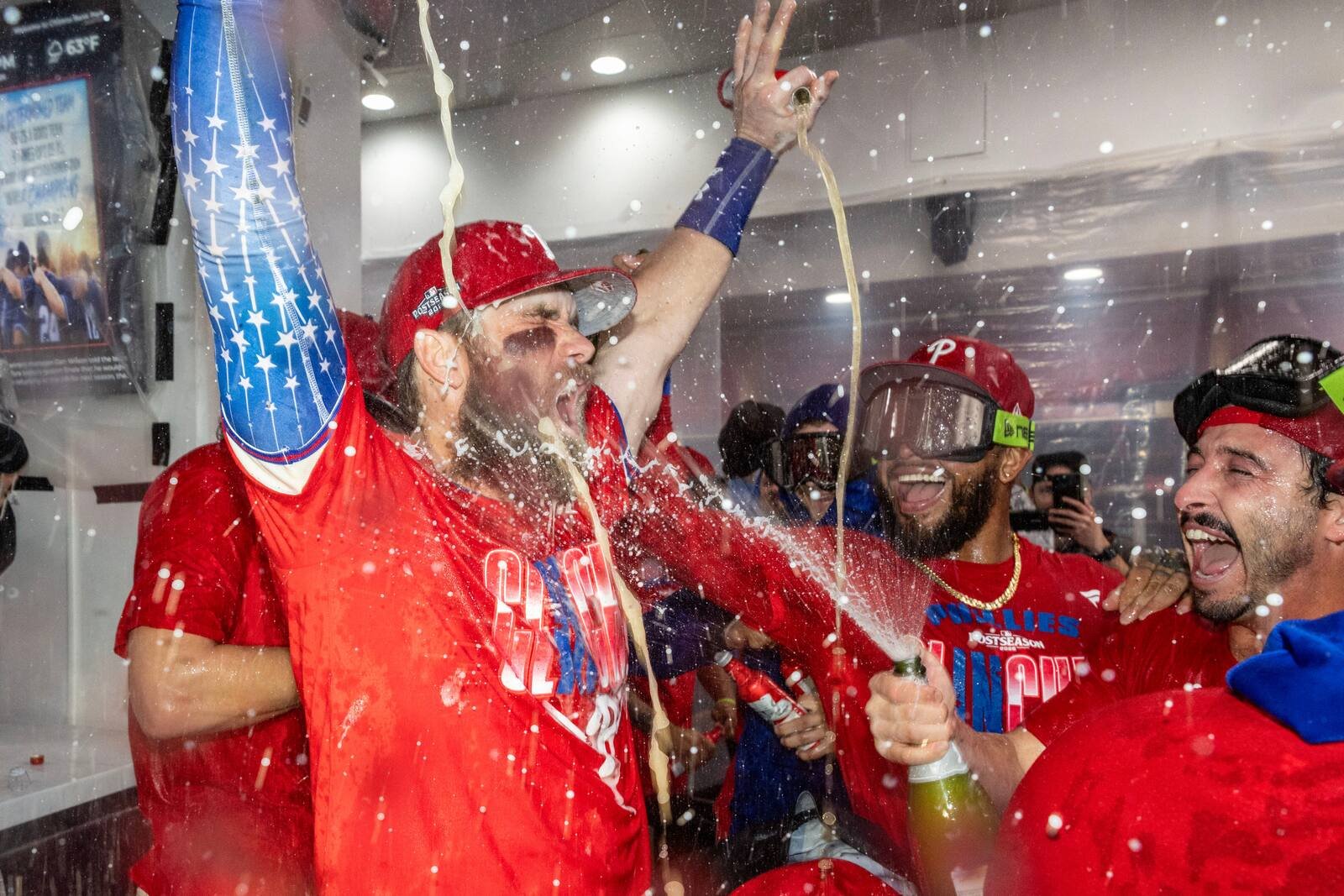 Bryce Harper and Phillies teammates celebrate their postseason berth with champagne in Philadelphia on September 27, 2026.