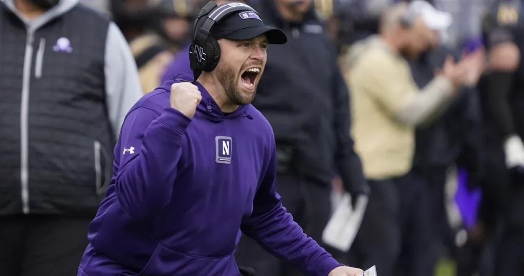 Northwestern head coach David Braun celebrating on the sideline