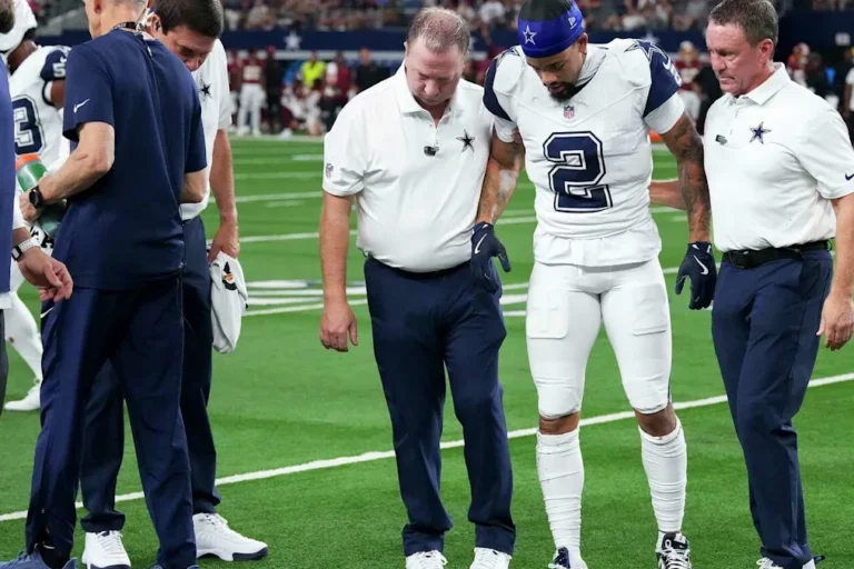 Cowboys cornerback Cobie Durant walks off the field with staff after his injury against Washington.