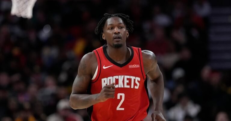 Dorian Finney-Smith appears in his red Houston Rockets uniform.