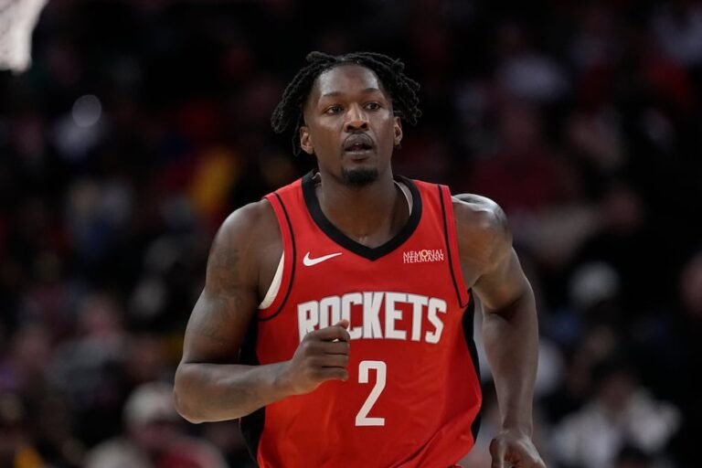 Dorian Finney-Smith appears in his red Houston Rockets uniform.