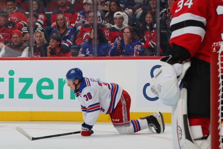 Adam Sykora lies on the ice during the Rangers preseason game against New Jersey.