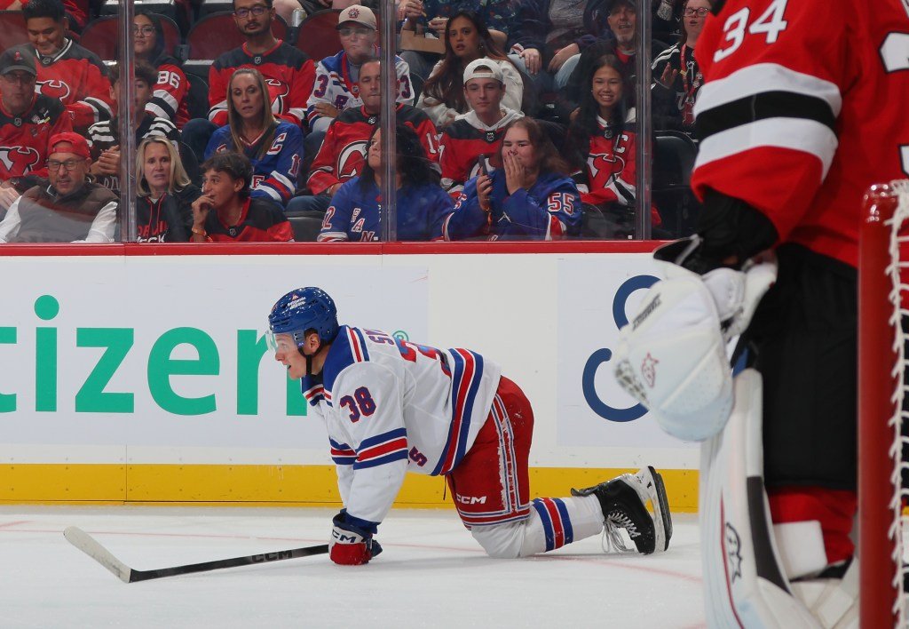 Adam Sykora lies on the ice during the Rangers preseason game against New Jersey.