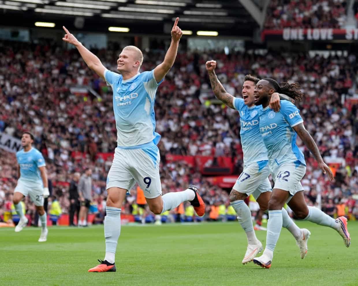 Erling Haaland celebrates after VAR awards his goal at Old Trafford.