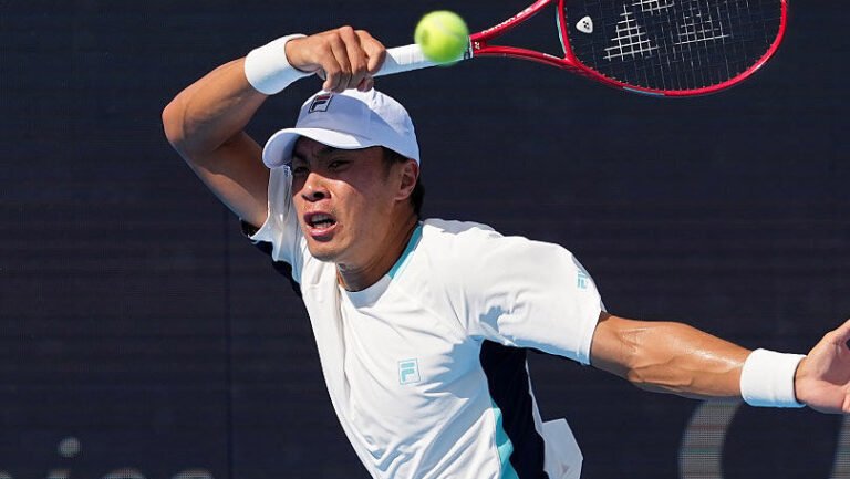 Brandon Nakashima prepares to strike the ball during a match.