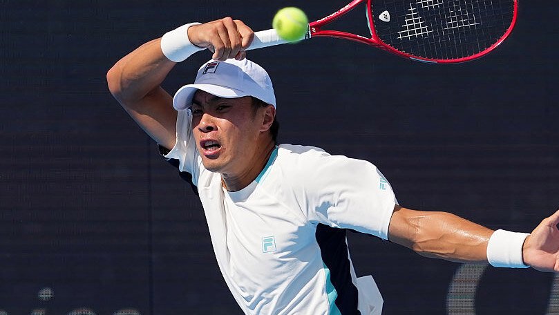 Brandon Nakashima prepares to strike the ball during a match.