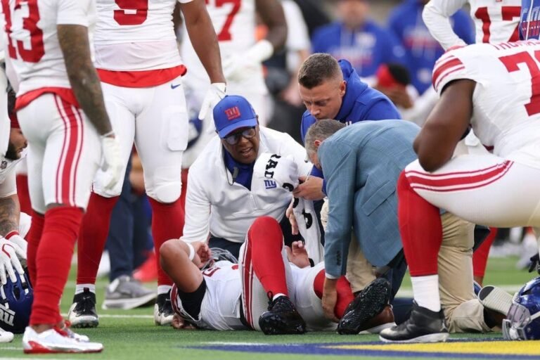 Jaxson Dart lies on the field after his injury against the Rams.