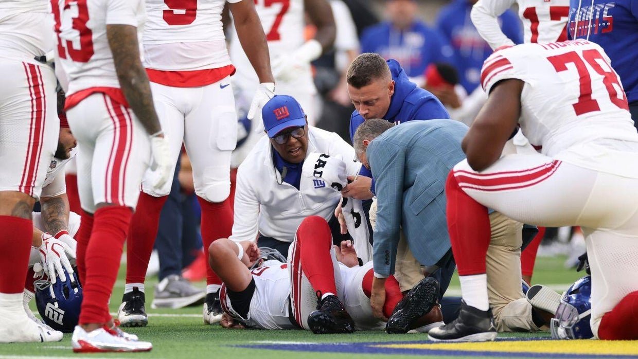 Jaxson Dart lies on the field after his injury against the Rams.