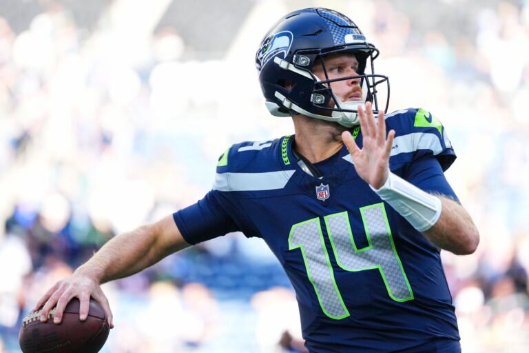 Sam Darnold warms up before Seattle’s opener against New England.