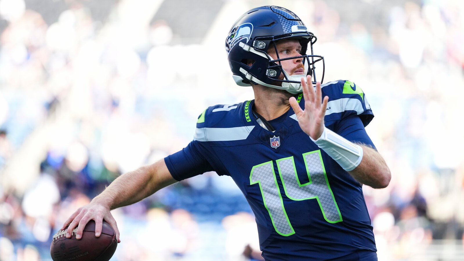 Sam Darnold warms up before Seattle’s opener against New England.
