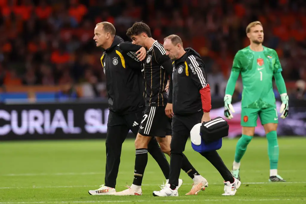 Kai Havertz walks off with Germany staff during the Netherlands match.