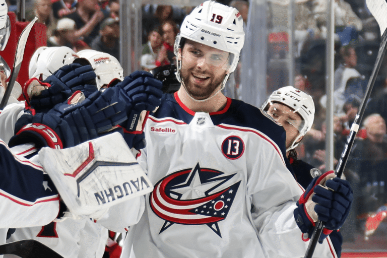 Adam Fantilli in a Blue Jackets uniform celebrates with teammates.