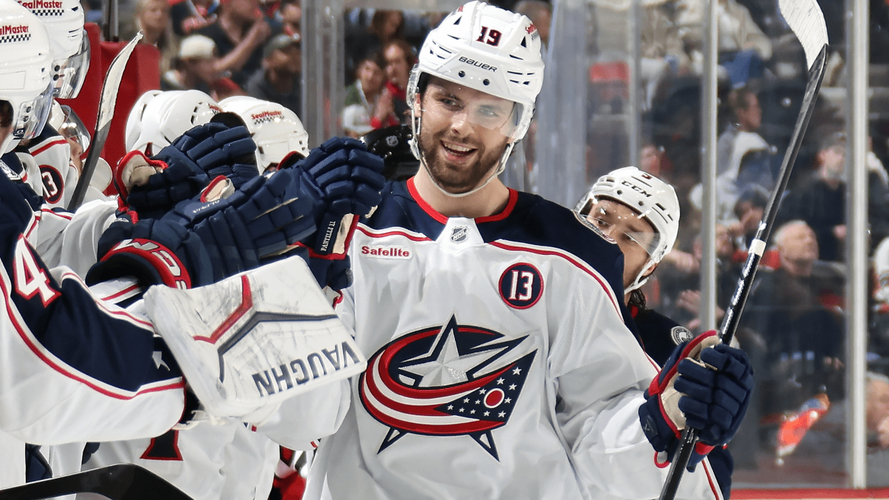 Adam Fantilli in a Blue Jackets uniform celebrates with teammates.