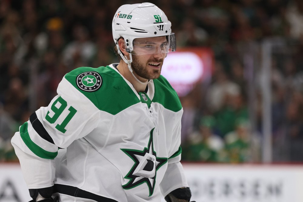 Tyler Seguin skates in a white Dallas Stars jersey.