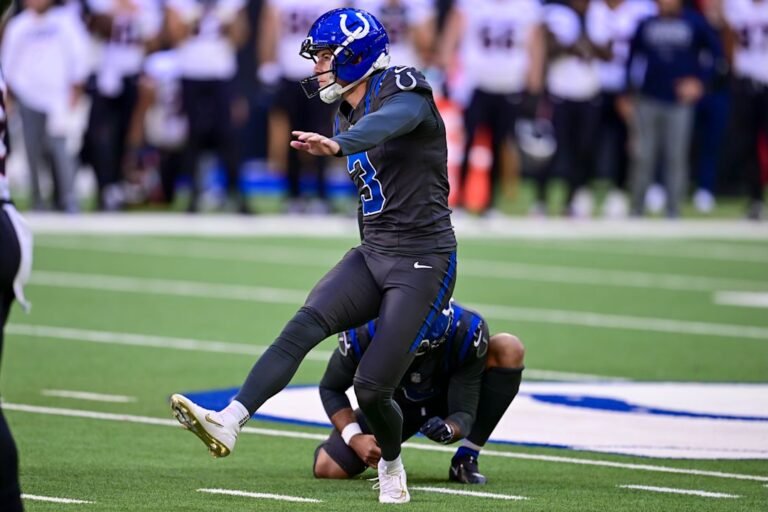 Colts kicker Spencer Shrader follows through on a kick with Rigoberto Sanchez holding.