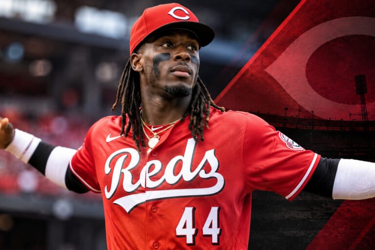Illustration of Elly De La Cruz in a Cincinnati Reds uniform against a red-and-black stadium background.