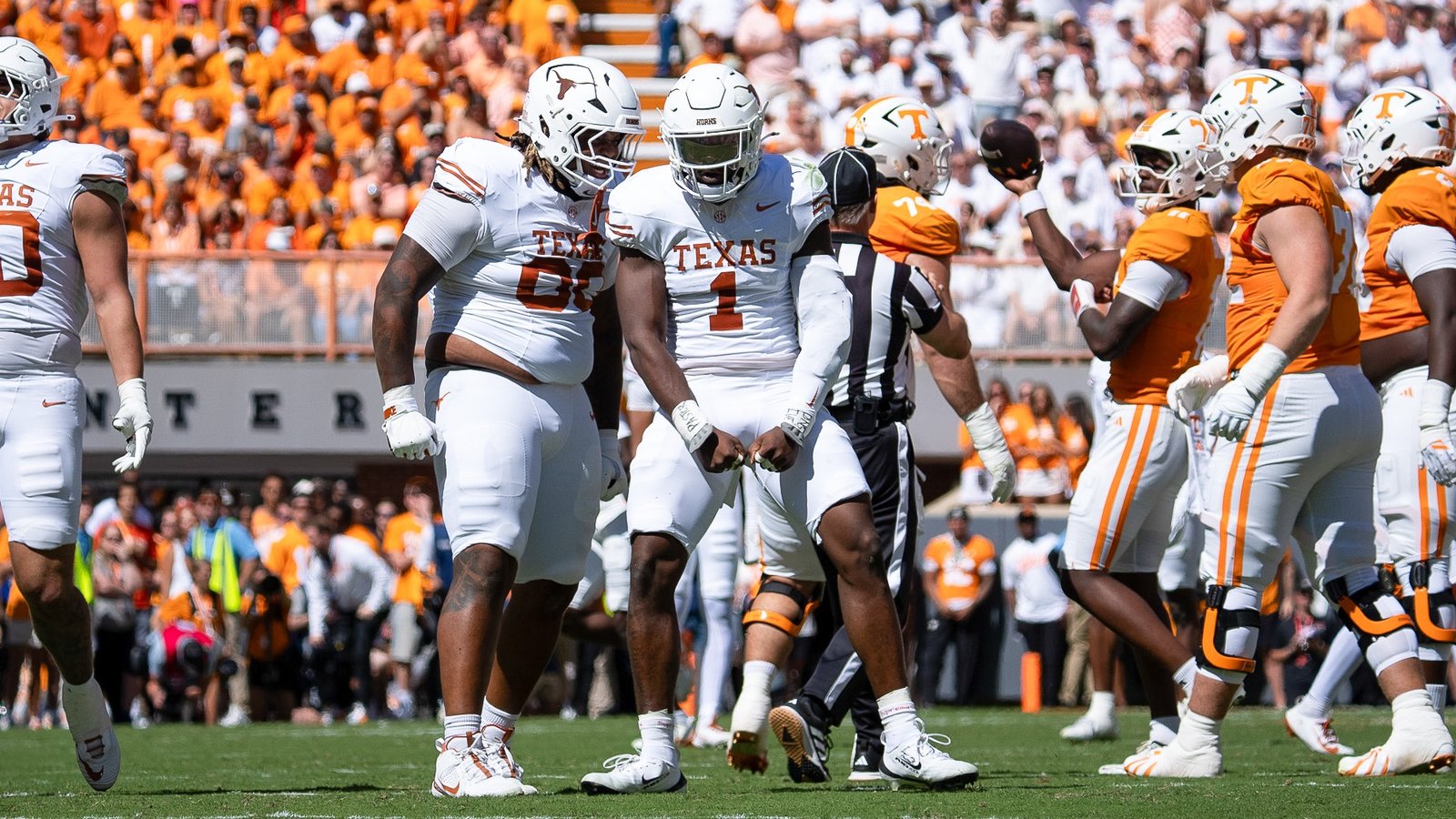 Texas defenders Hero Kanu and Colin Simmons celebrate a sack against Tennessee.