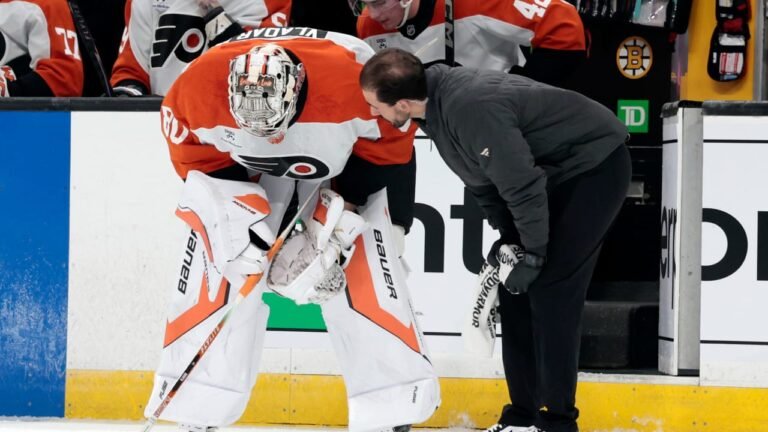 Dan Vladar receives attention beside the Flyers bench during the preseason game in Boston.