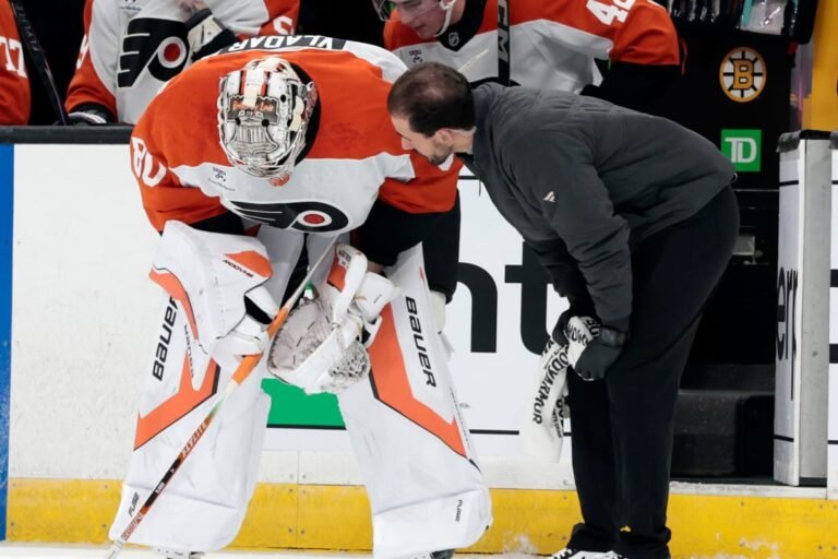 Dan Vladar receives attention beside the Flyers bench during the preseason game in Boston.