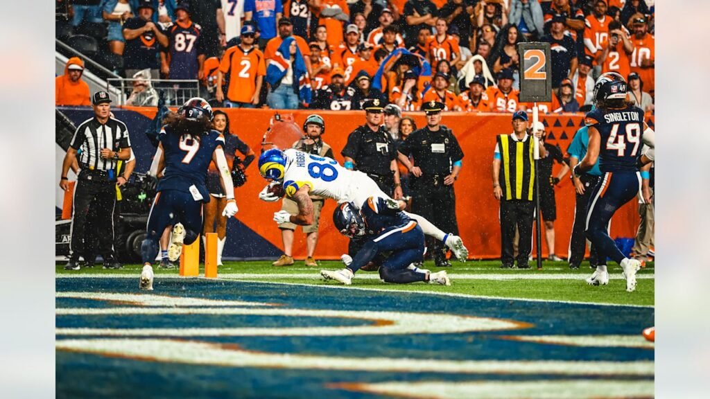 Tyler Higbee dives toward the goal line as Denver defenders tackle him during Rams–Broncos on September 27, 2026.