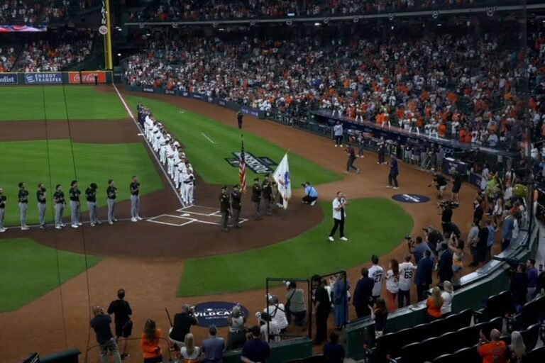 White Sox and Astros players line the field at Daikin Park for the national anthem before Wild Card Game 1 on September 29, 2026.