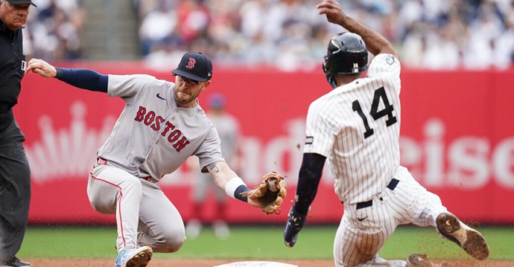 Boston’s Trevor Story reaches to tag New York’s Amed Rosario at Yankee Stadium on August 30, 2026.
