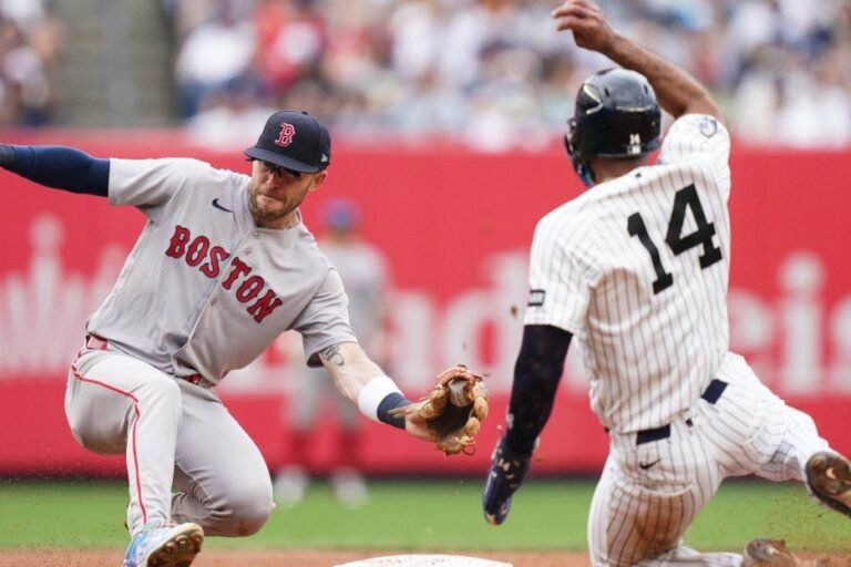 Boston’s Trevor Story reaches to tag New York’s Amed Rosario at Yankee Stadium on August 30, 2026.