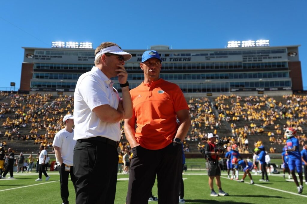 Florida coach Jon Sumrall, right, talks with Missouri coach Eli Drinkwitz before their October 3 game in Columbia.