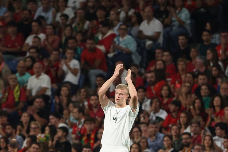 Erling Haaland applauds in a Norway national team jersey.