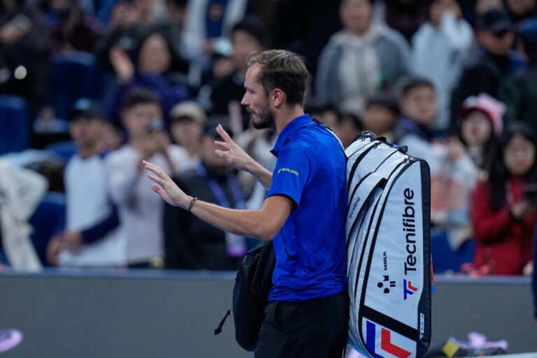 Daniil Medvedev walks off court carrying his tennis bag.