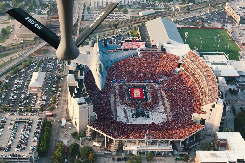 A National Guard flyover above a packed Memorial Stadium during Volleyball Day in Nebraska in 2023.