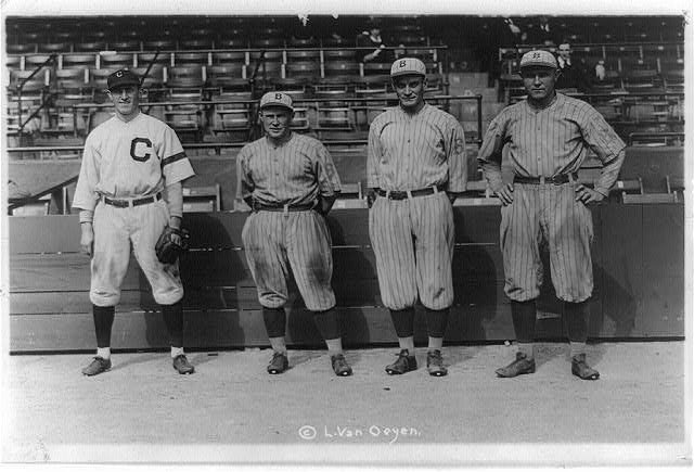 Bill Wambsganss poses with three Brooklyn players after the 1920 World Series triple play.
